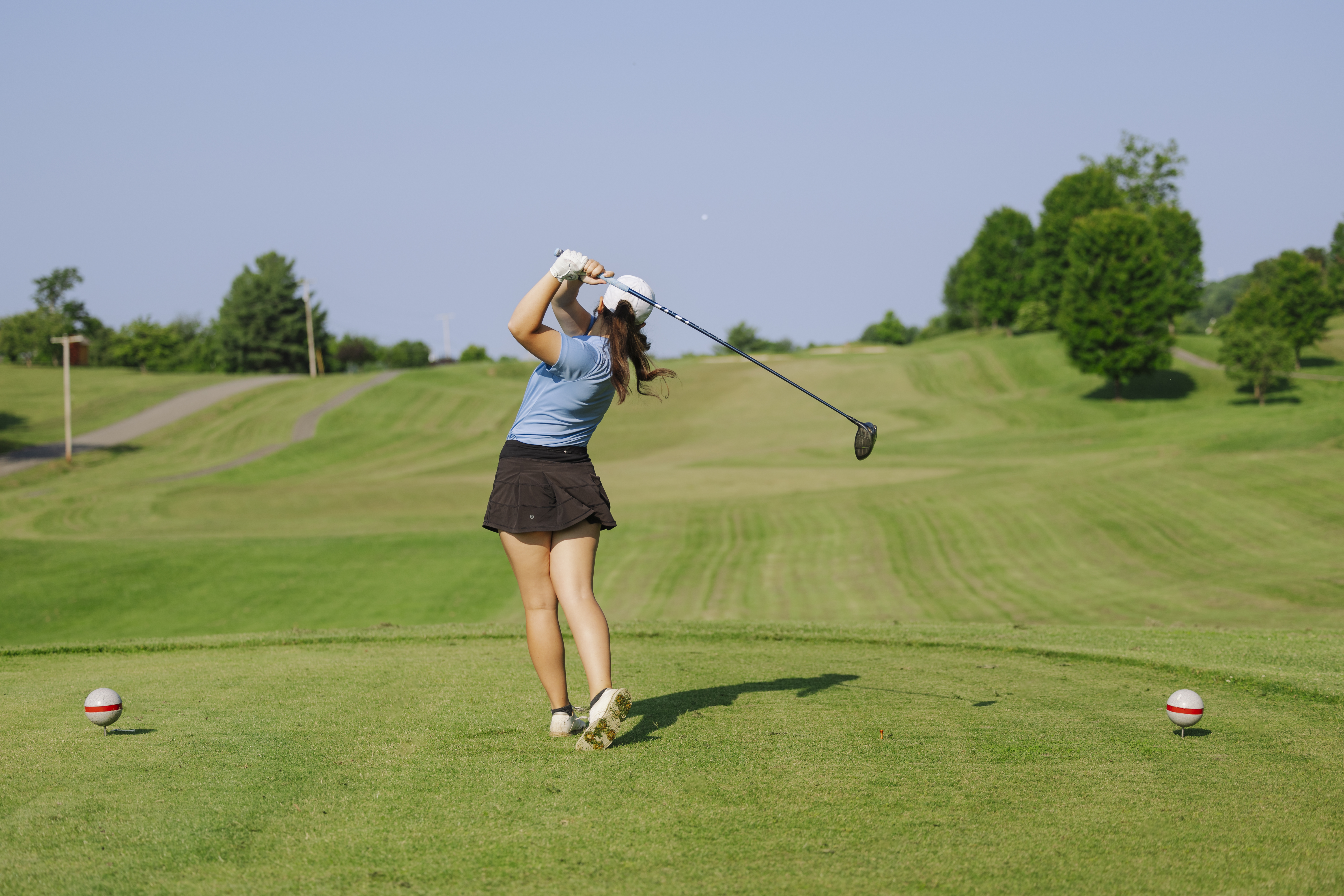Golfer taking a swing on green