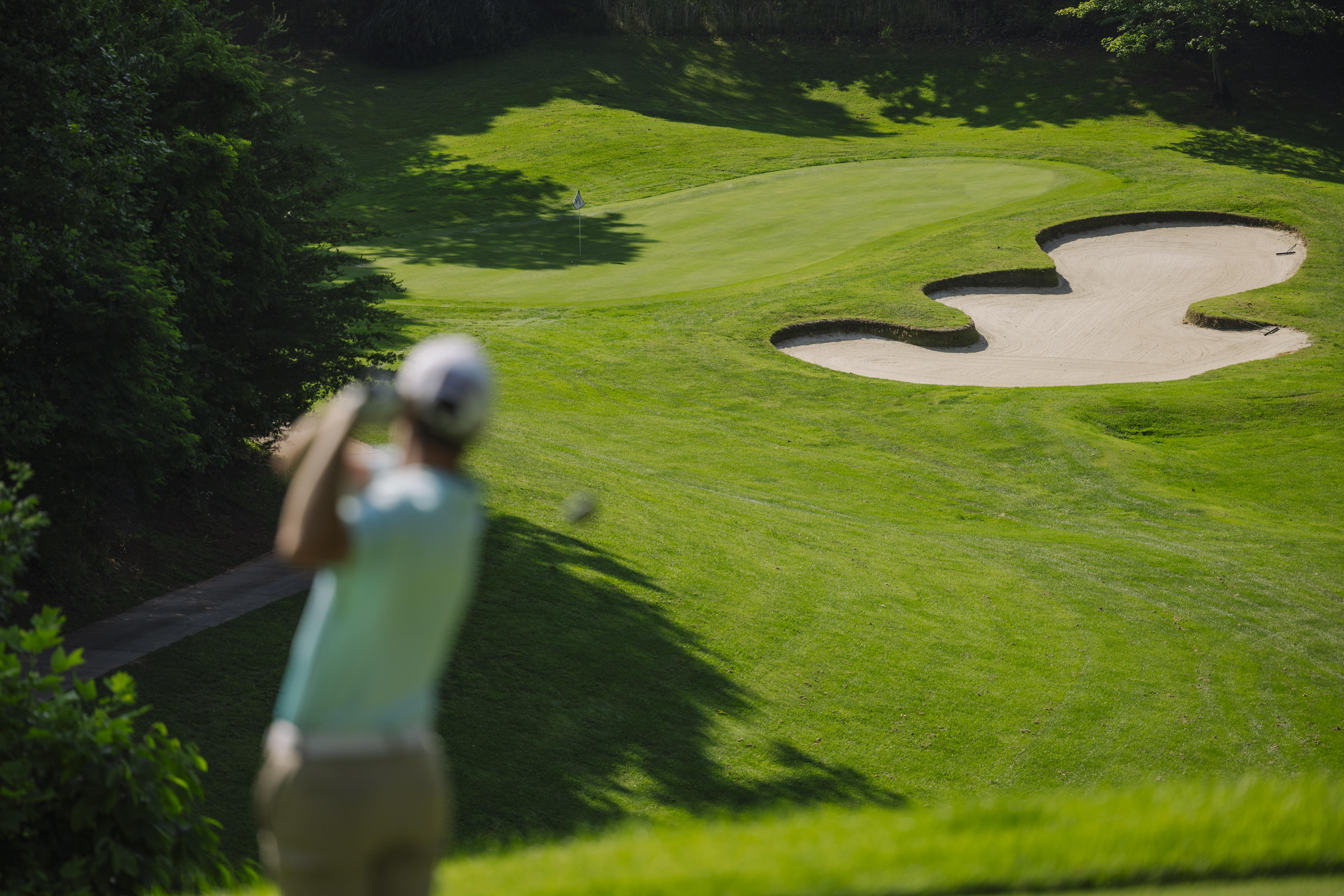 Golfer taking a swing on golf course